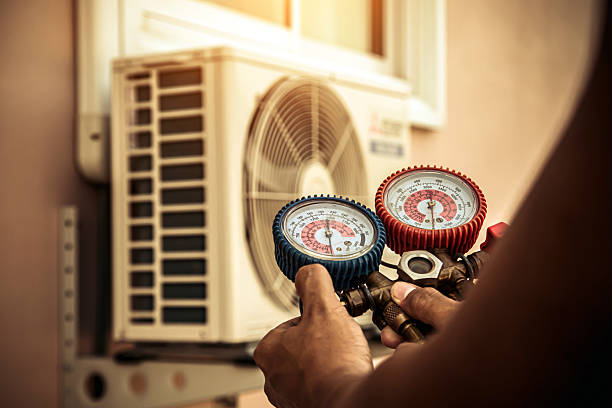 Professional Air Conditioning Service technician working in Mentone, CA